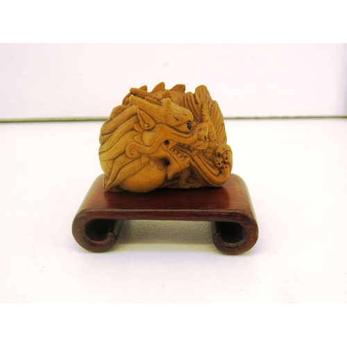 57 - CHINESE CARVED DRAGON NETSUKE AND STAND