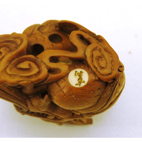 57 - CHINESE CARVED DRAGON NETSUKE AND STAND