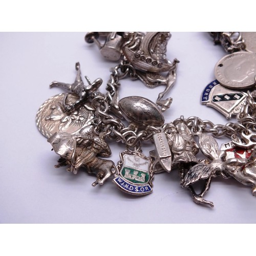 88 - STERLING SILVER CHARM BRACELET WITH 30 SILVER CHARMS - weight 68g
