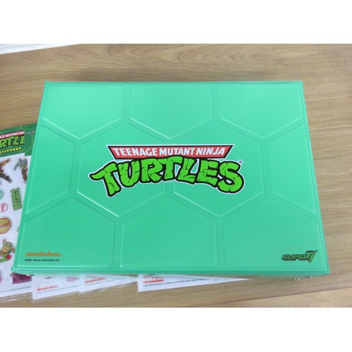 41 - 4 x SUPER 7 TEENAGE MUTANT NINJA TURTLES CASES EACH WITH ONE FIGURE AND 4 SHEETS OF NINJA TURTLES ST... 