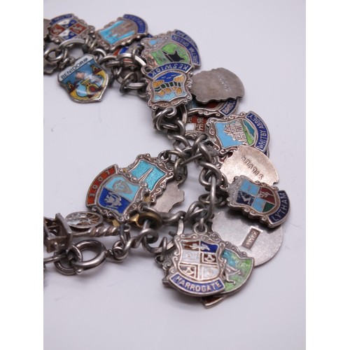 71 - STERLING SILVER CHARM BRACELET WITH SILVER CHARMS & SILVER & ENAMEL SOUVENIR SHIELD CHARMS 60g