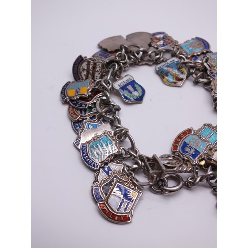 71 - STERLING SILVER CHARM BRACELET WITH SILVER CHARMS & SILVER & ENAMEL SOUVENIR SHIELD CHARMS 60g