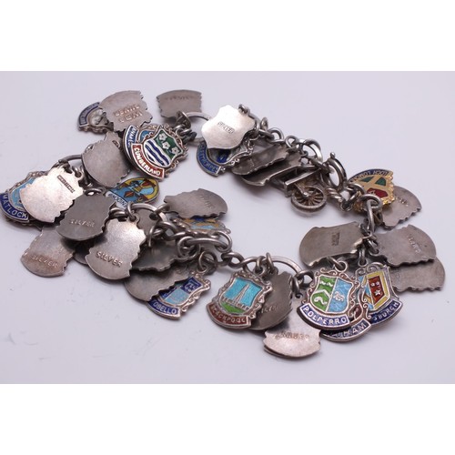 71 - STERLING SILVER CHARM BRACELET WITH SILVER CHARMS & SILVER & ENAMEL SOUVENIR SHIELD CHARMS 60g