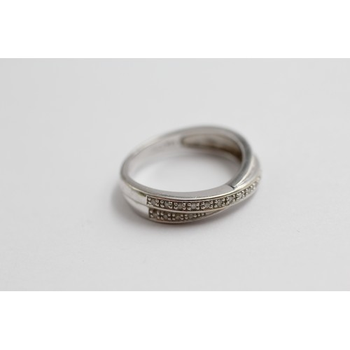 402 - 9ct white gold diamond crossover ring (2.8g)