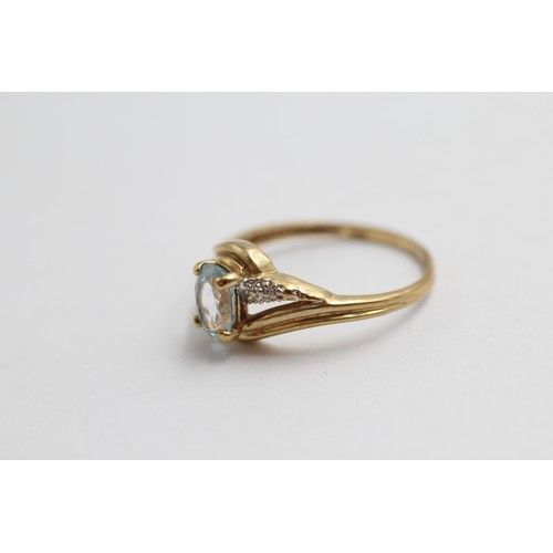 406 - 9ct gold blue topaz & diamond twist setting ring (1.8g)-SIZE P