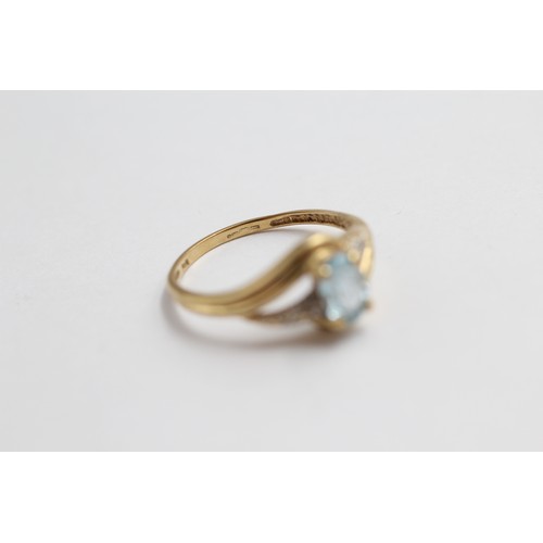 406 - 9ct gold blue topaz & diamond twist setting ring (1.8g)-SIZE P