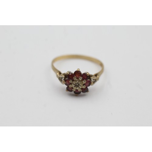 468 - 9ct gold ruby and diamond floral halo ring (2.2g)- SIZE P