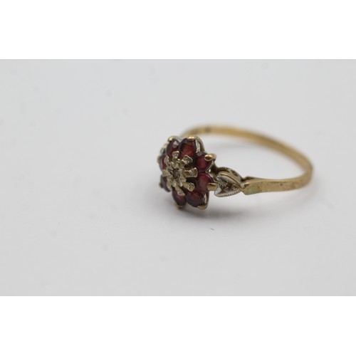 468 - 9ct gold ruby and diamond floral halo ring (2.2g)- SIZE P