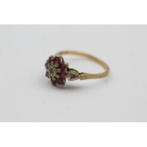 468 - 9ct gold ruby and diamond floral halo ring (2.2g)- SIZE P