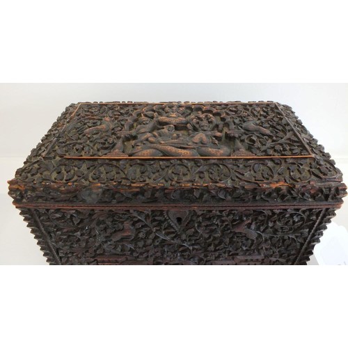 91 - AN INDIAN CARVED SANDALWOOD TEA CADDY, BOMBAY the lid and sides with raised panels of figures, anima... 