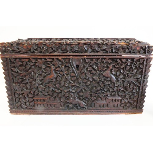 91 - AN INDIAN CARVED SANDALWOOD TEA CADDY, BOMBAY the lid and sides with raised panels of figures, anima... 