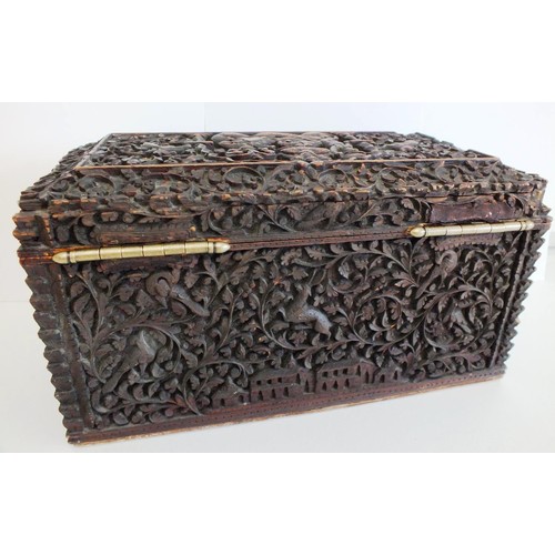 91 - AN INDIAN CARVED SANDALWOOD TEA CADDY, BOMBAY the lid and sides with raised panels of figures, anima... 