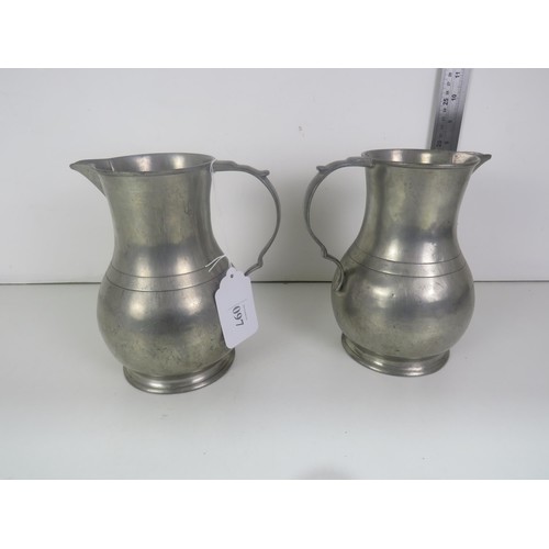 97 - PAIR OF ANTIQUE HEAVY PEWTER JUGS/ BOTH STAMPED ON THE BASES - Height 21cms