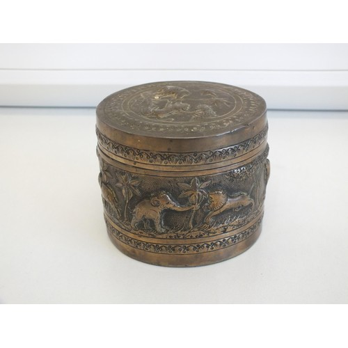 269 - ROUND COLONIAL INDIAN SILVER BOX WITH FIGURAL WORK DEPICTING DIFFERENT ANIMALS INCLUDING ELEPHANTS, ... 