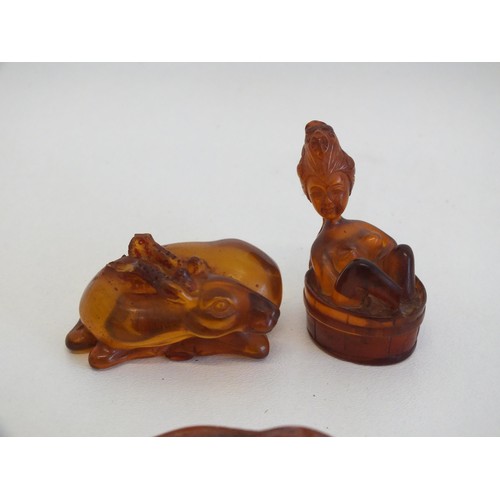 274 - 2 AMBER NETSUKES INCLUDES JAPANESE LADY IN A BATH TUB (AS FOUND) and A PIECE OF NATURAL RAW AMBER AP... 