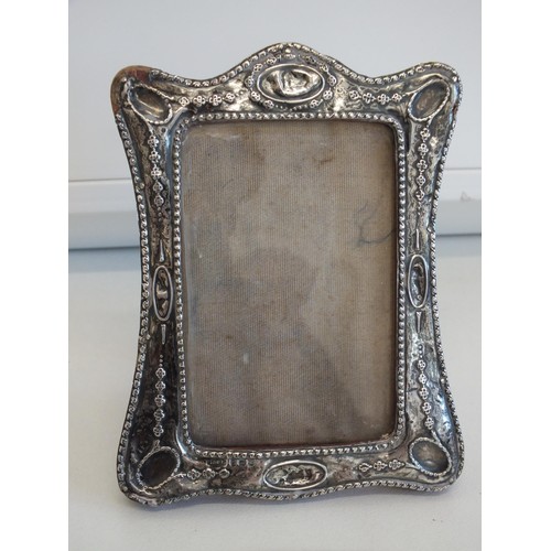 233 - ORNATE 1916 STERLING SILVER PHOTOGRAPH FRAME 12cms x 9cms and STERLING SILVER CHERUB BOOK COVER