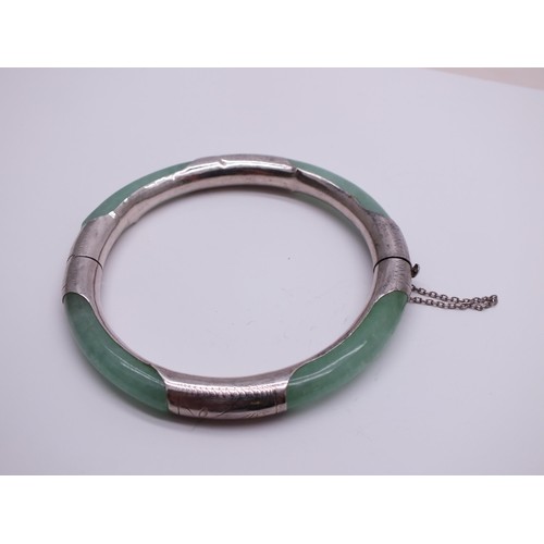 240 - ORIENTAL NATURAL JADE AND STERLING SILVER BANGLE WITH SAFETY CHAIN