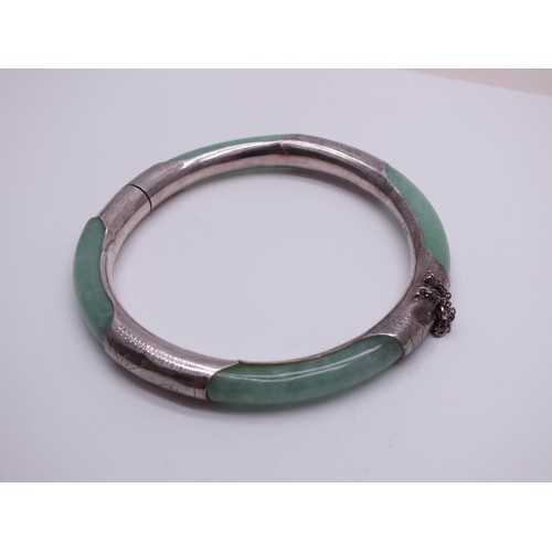 240 - ORIENTAL NATURAL JADE AND STERLING SILVER BANGLE WITH SAFETY CHAIN