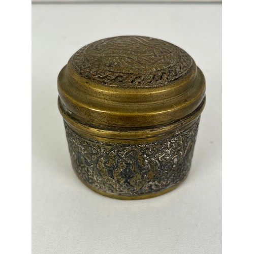 270 - CAIRO WARE CIRCULAR BRASS TRINKET BOX INLAID WITH SILVER ISLAMIC SCRIPT, height 5cms width 6.5cms