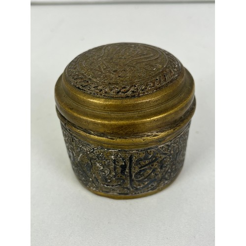 270 - CAIRO WARE CIRCULAR BRASS TRINKET BOX INLAID WITH SILVER ISLAMIC SCRIPT, height 5cms width 6.5cms