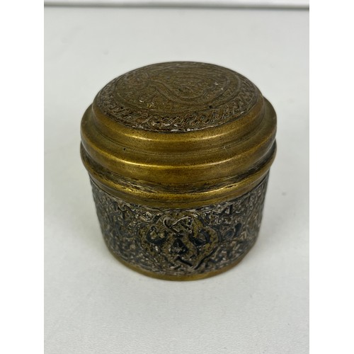 270 - CAIRO WARE CIRCULAR BRASS TRINKET BOX INLAID WITH SILVER ISLAMIC SCRIPT, height 5cms width 6.5cms