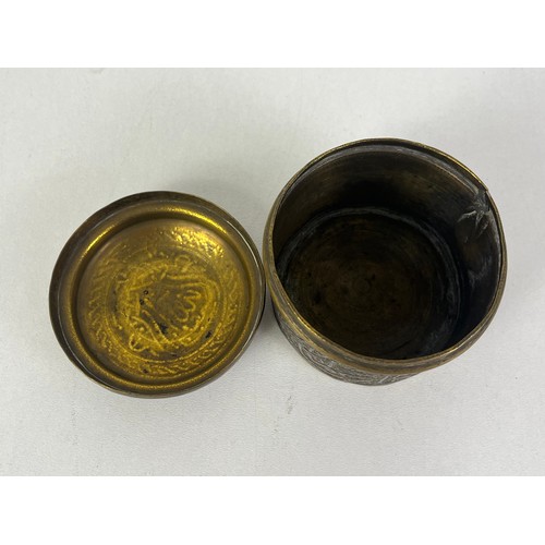 270 - CAIRO WARE CIRCULAR BRASS TRINKET BOX INLAID WITH SILVER ISLAMIC SCRIPT, height 5cms width 6.5cms