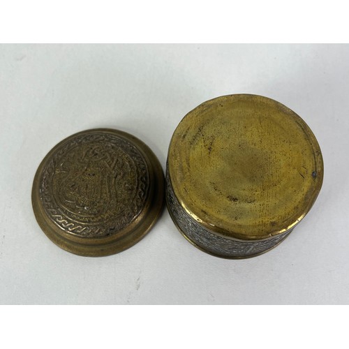 270 - CAIRO WARE CIRCULAR BRASS TRINKET BOX INLAID WITH SILVER ISLAMIC SCRIPT, height 5cms width 6.5cms