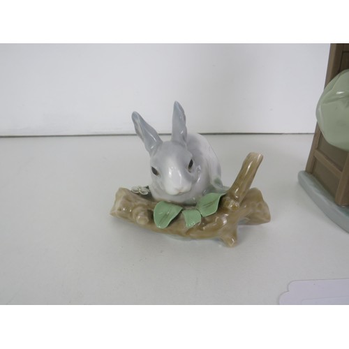 92 - TWO LLADRO FIGURES- GIRL SITTING ON CHAIR WITH VASE OF FLOWERS AND RABBIT EATING LEAVES