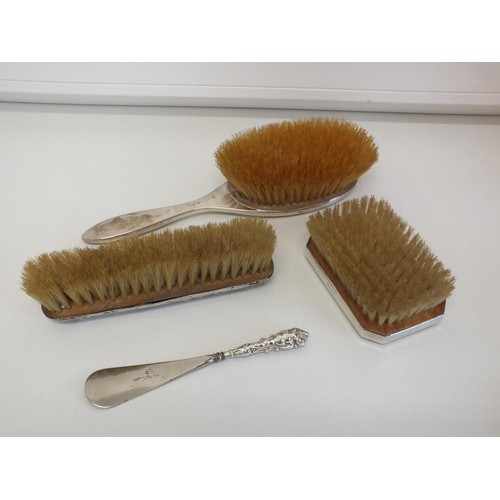 286 - 3 x SILVER BACKED HAIR BRUSHES AND A SILVER SHOE HORN