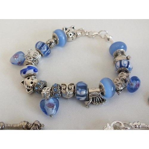 240 - 7 ASSORTED FASHION CHARM BRACELETS