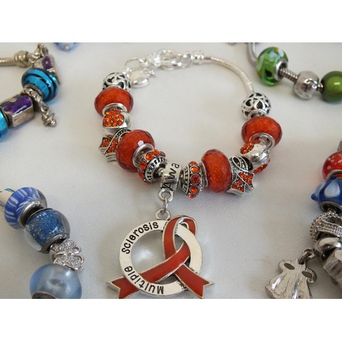 240 - 7 ASSORTED FASHION CHARM BRACELETS