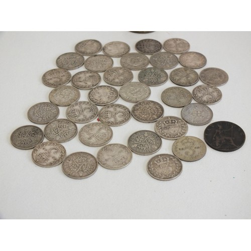 364 - 35 SILVER THREE PENCE COINS IN A MAGIC POCKET SAVINGS BANK