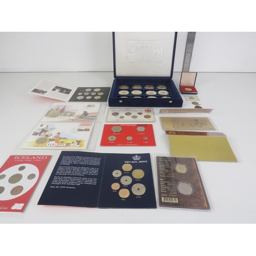 64 - COLLECTORS COINS INCLUDES CHINA COMMEMORATIVE COIN COLLECTION, DENMARK COVER COINS AND COIN SET etc