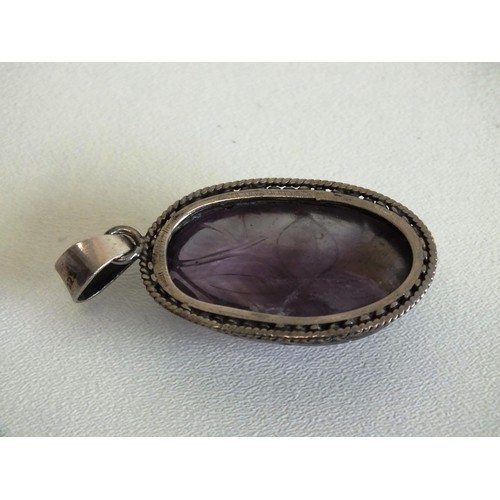 83 - CARVED AMETHYST PENDANT SET IN 925 SILVER MOUNT AND PAIR OF 925 SILVER MARCASITE AND AMETHYST EARRIN... 