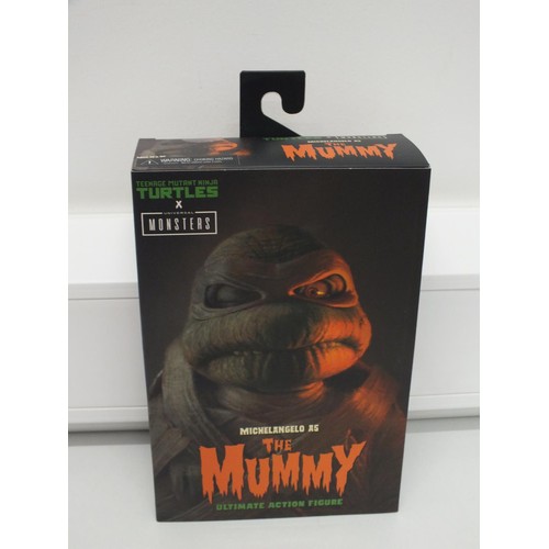 24 - NECA Teenage Mutant Ninja Turtles X Universal Monsters Michelangelo as The Mummy Ultimate Action Fig... 