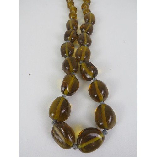 269 - AMBER GLASS, HAND KNOTTED NECKLACE APPROXIMATELY 116cm IN LENGTH