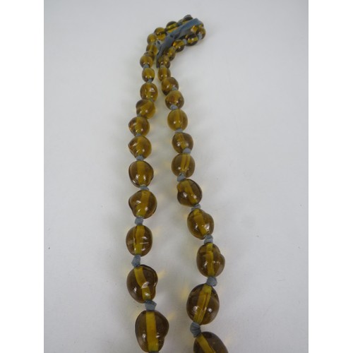 269 - AMBER GLASS, HAND KNOTTED NECKLACE APPROXIMATELY 116cm IN LENGTH