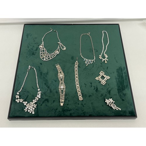 43 - LARGE GREEN BRUSHED VELVET JEWELLERY DISPLAY BOARD WITH 8 x SILVERTONE PASTE JEWELLERY SIZE 47 x 47c... 