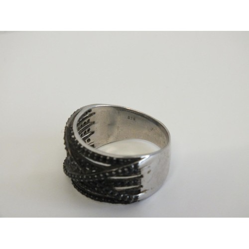 43 - LARGE STERLING SILVER BLACK STONE CROSSOVER RING SIZE V