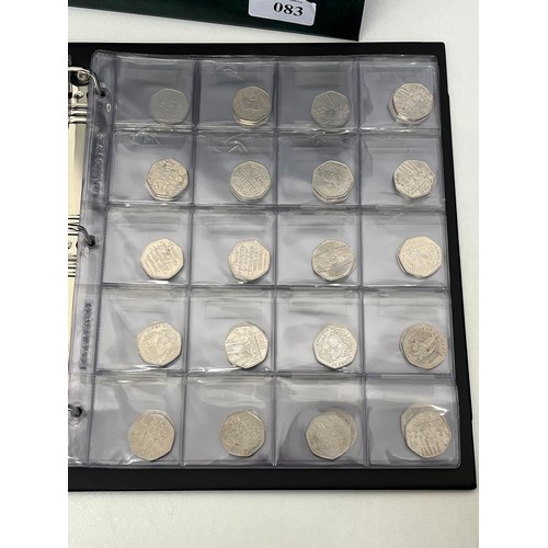 83 - 100 x COLLECTABLE FIFTY PENCE COINS IN GREEN LEATHERETTE COIN ALBUM INCLUDES BEATRIX POTTER, PADDING... 