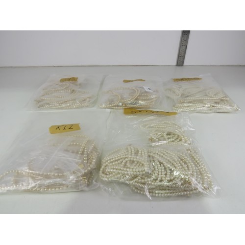 389 - FIVE BAGS OF FAUX PEARL NECKLACES