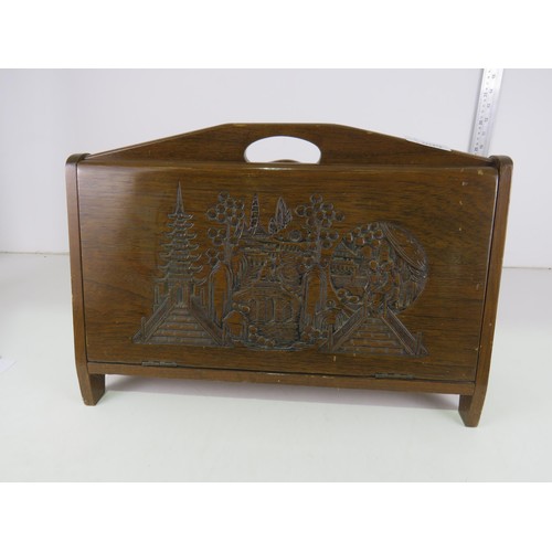 9 - Wooden magazine rack with oriental carved detail.