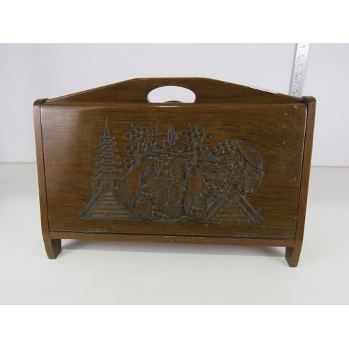 9 - Wooden magazine rack with oriental carved detail.