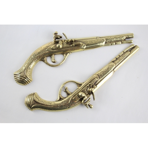 459 - Pair of ornamental brass flintlock pistols.