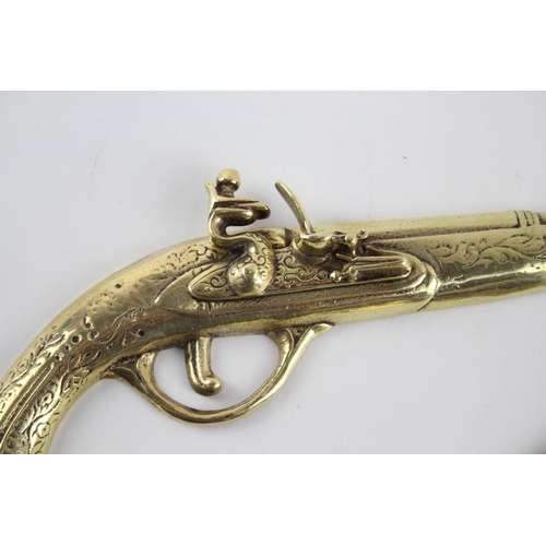 459 - Pair of ornamental brass flintlock pistols.