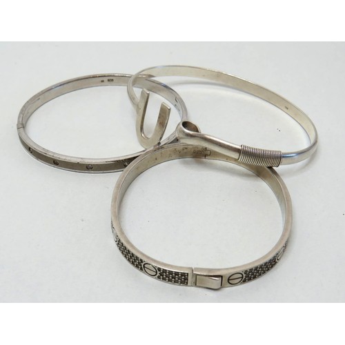 52 - Three 925 Silver bangles.
Weight 57g