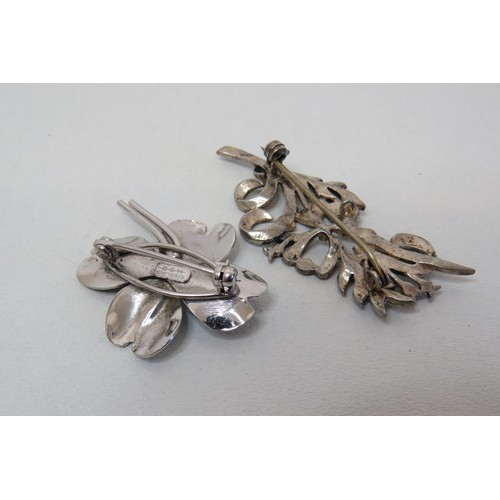 55 - Two silver brooches and two silver necklaces.