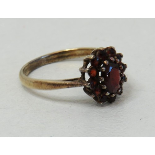 94 - 9ct Gold on Silver Garnet oval cluster ring size P.
Weight 2.1g.