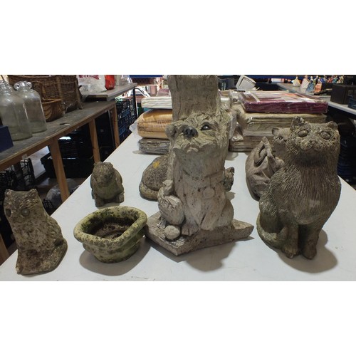 348 - Seven Concrete and stone garden ornaments as found includes cat in a bag, Rabbit, Dog by the tree, p... 