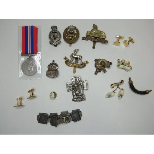 131 - Two silver A.R.P air raid badges, cap badge, medal etc.